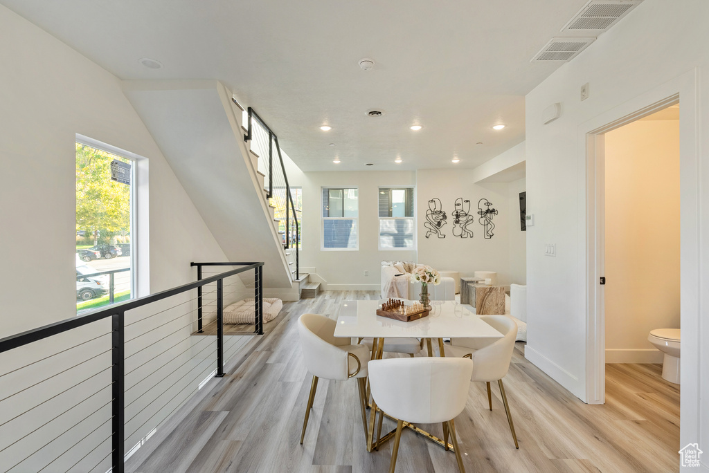 Dining room with light hardwood / wood-style flooring