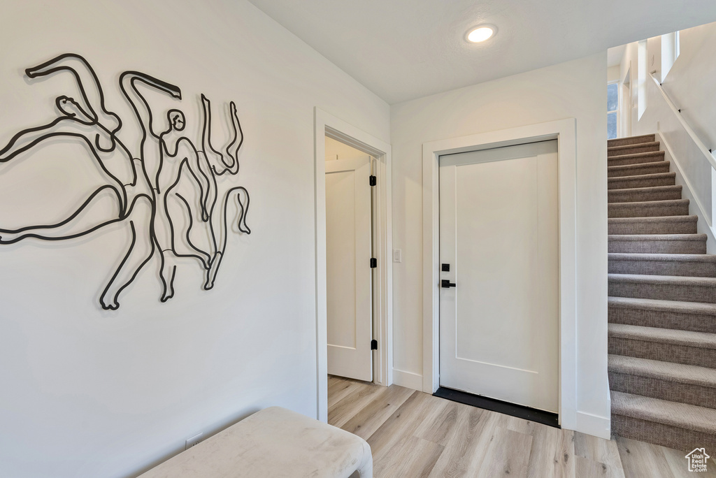 Entrance foyer with light wood-type flooring