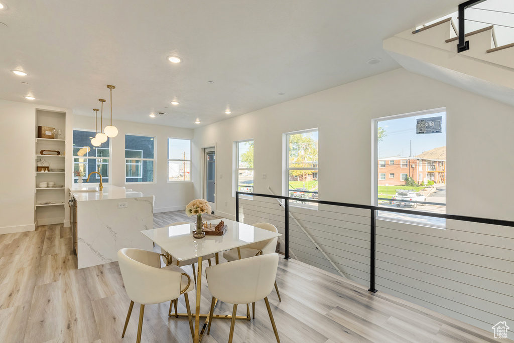 Dining space with sink and light hardwood / wood-style flooring