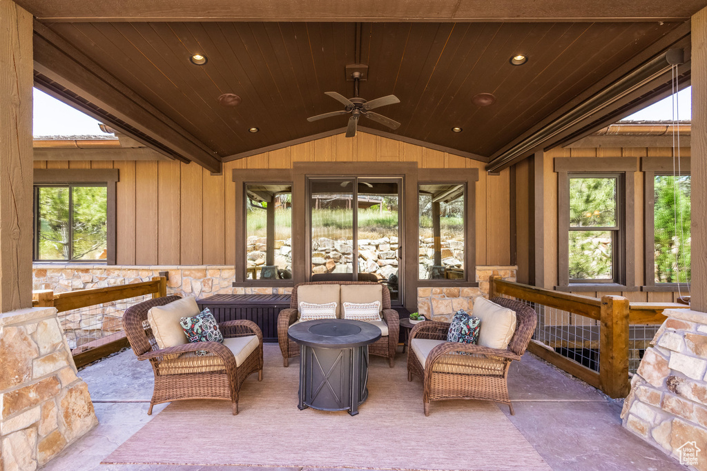 Sunroom / solarium featuring lofted ceiling, wood ceiling, and ceiling fan