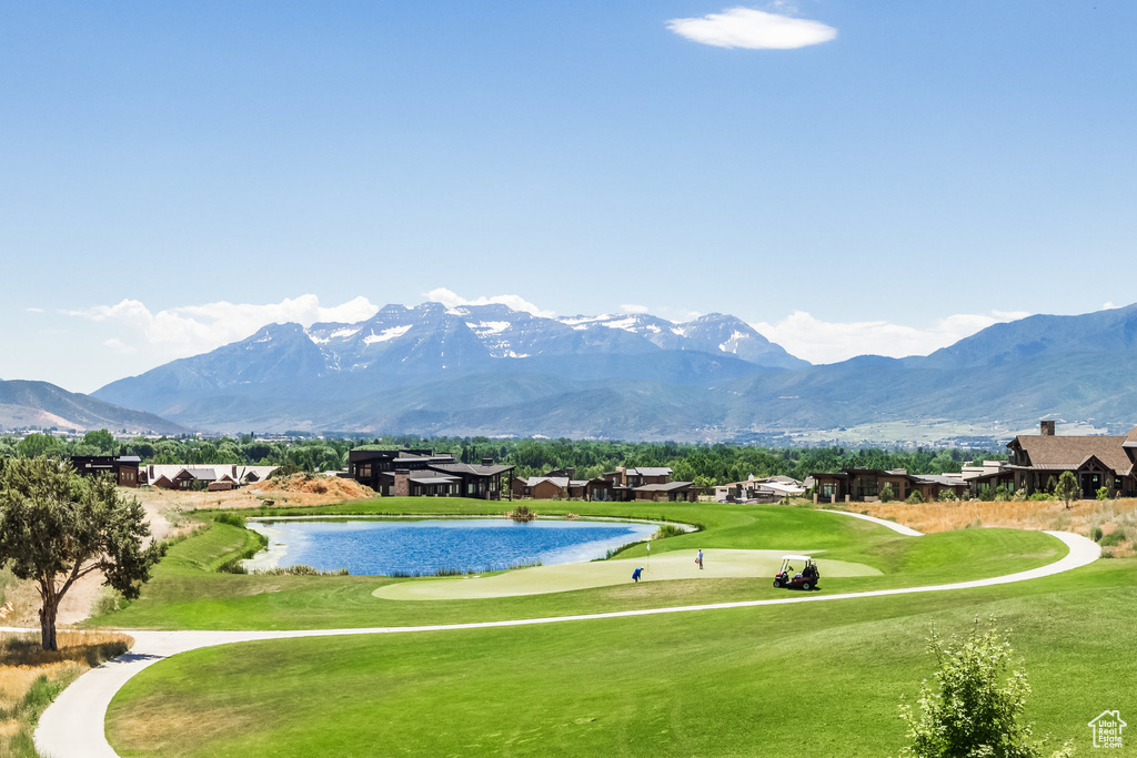 Surrounding community featuring a yard and a water and mountain view