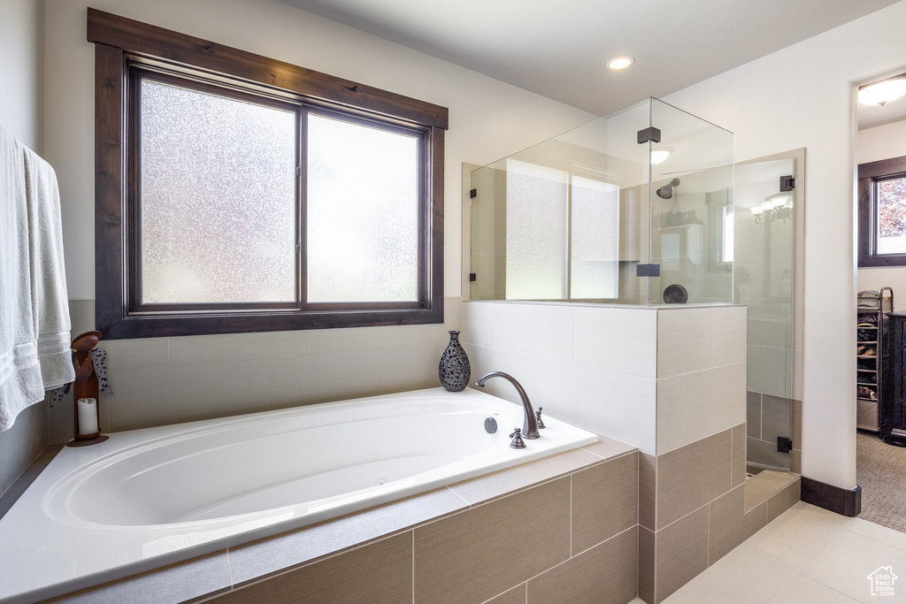 Bathroom with tile floors and plus walk in shower