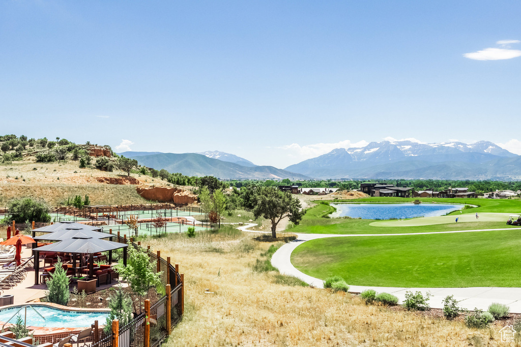 View of nearby features featuring a yard, a pool, and a water and mountain view