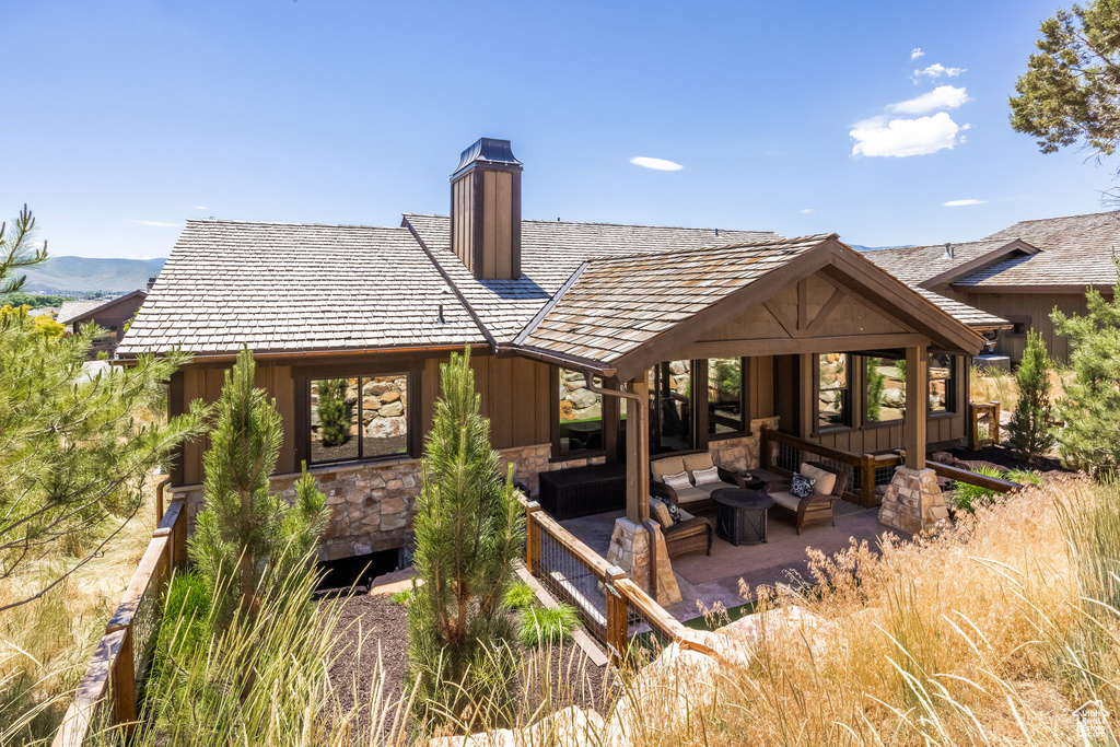 Rear view of property with outdoor lounge area