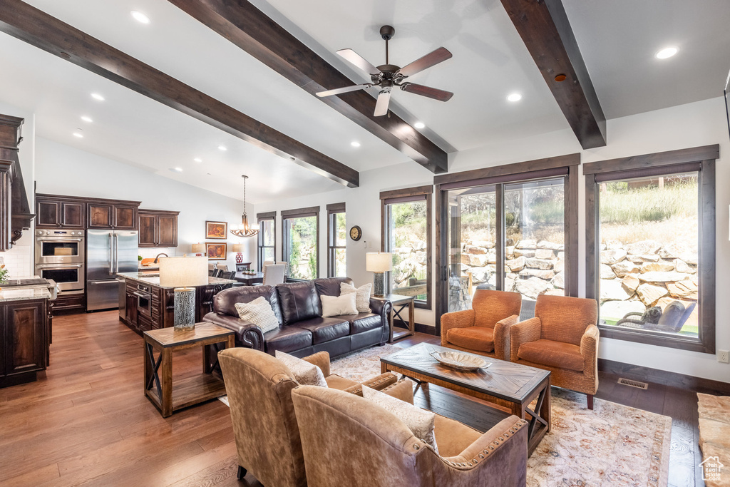 Living room featuring wood-type flooring, sink, lofted ceiling with beams, and ceiling fan