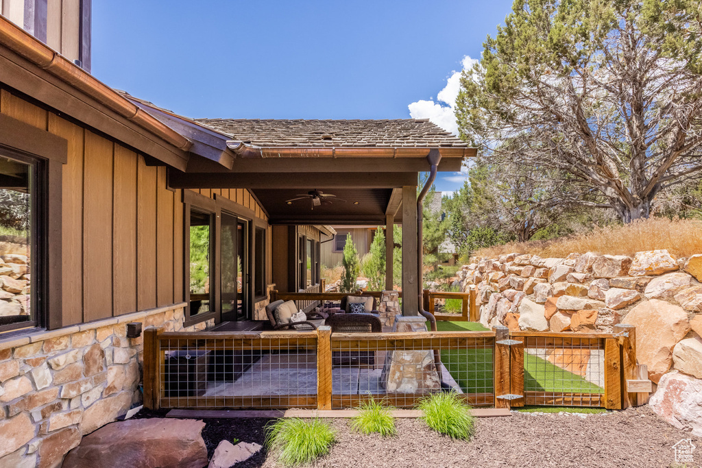 View of terrace featuring an outdoor living space and ceiling fan