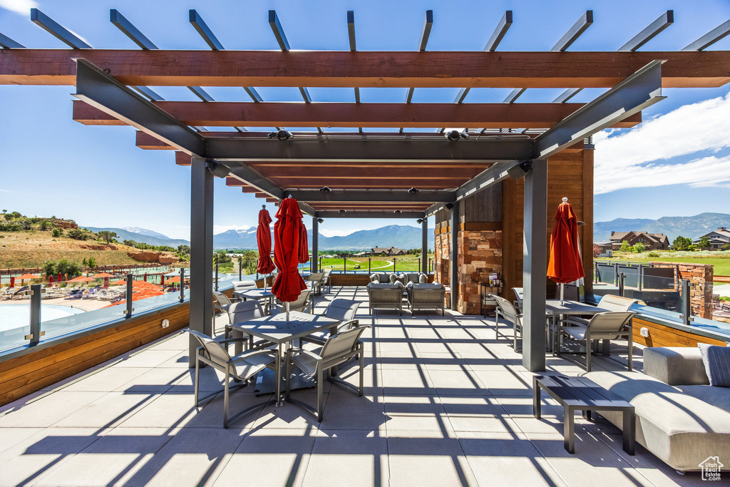 View of patio featuring a pergola, a mountain view, and an outdoor hangout area