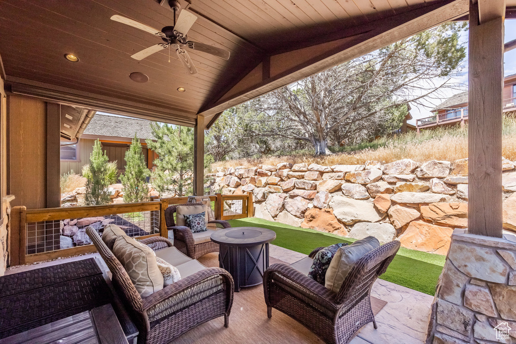 View of patio / terrace featuring an outdoor living space with a fire pit and ceiling fan