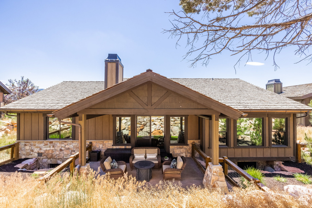 Rear view of house featuring an outdoor hangout area