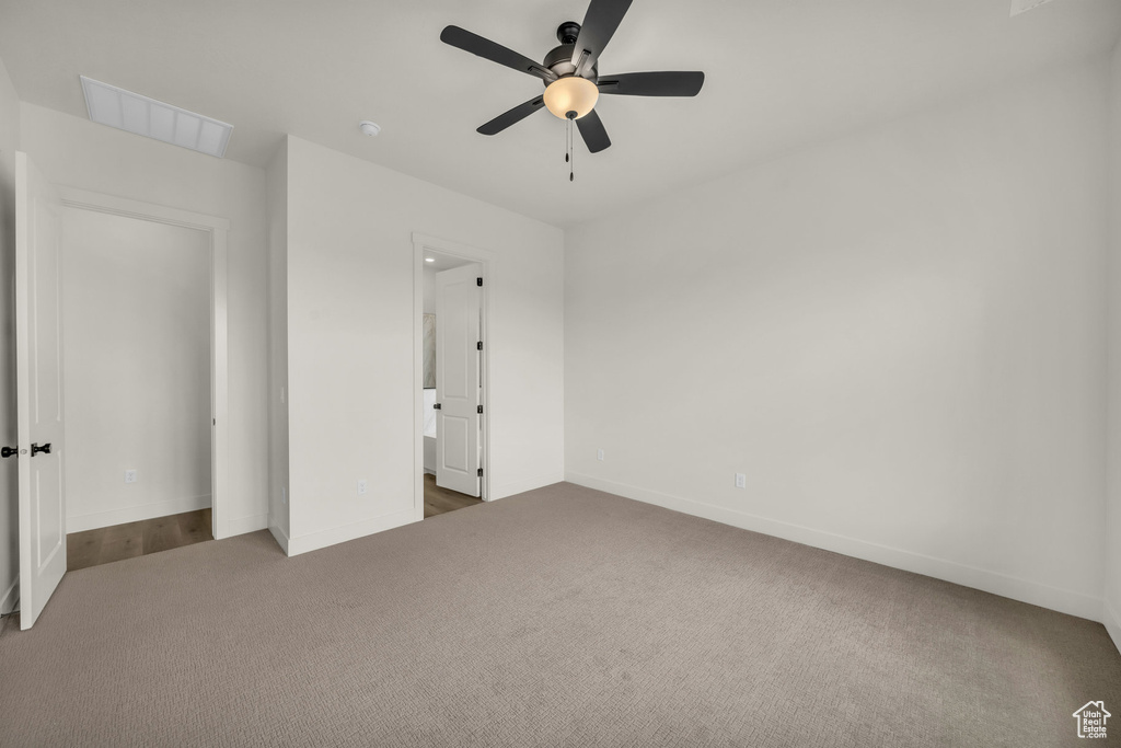 Unfurnished bedroom with ceiling fan and carpet flooring