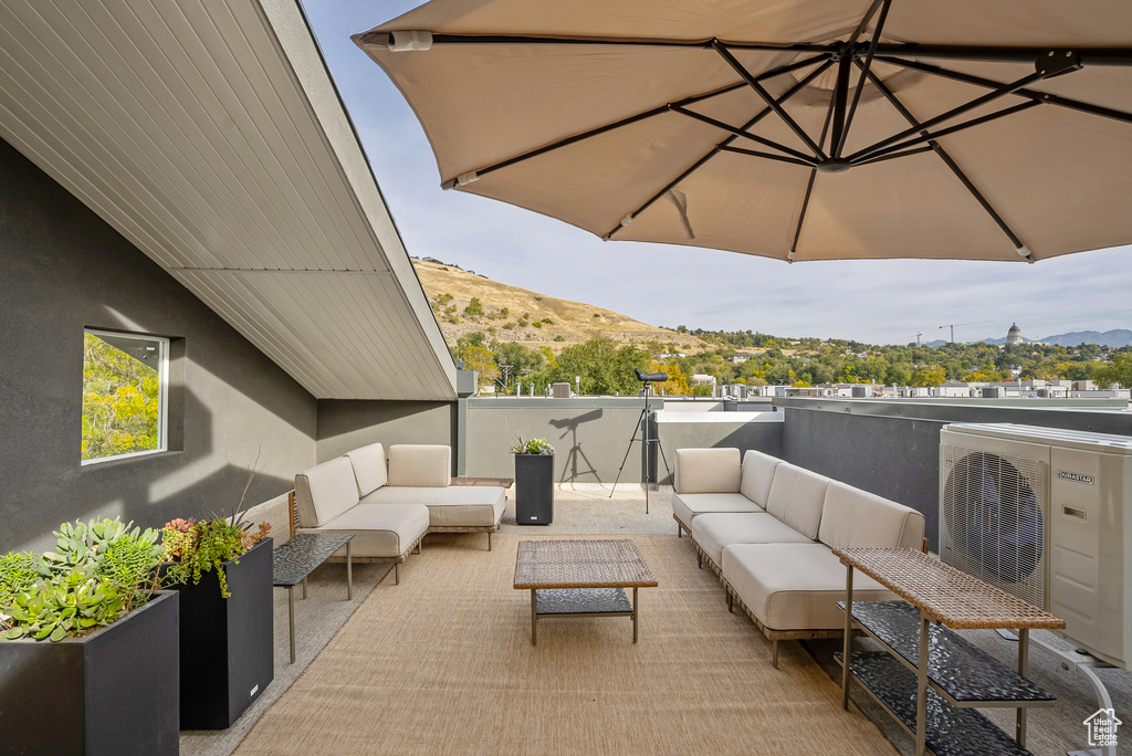 View of patio / terrace featuring ac unit, a mountain view, and an outdoor hangout area