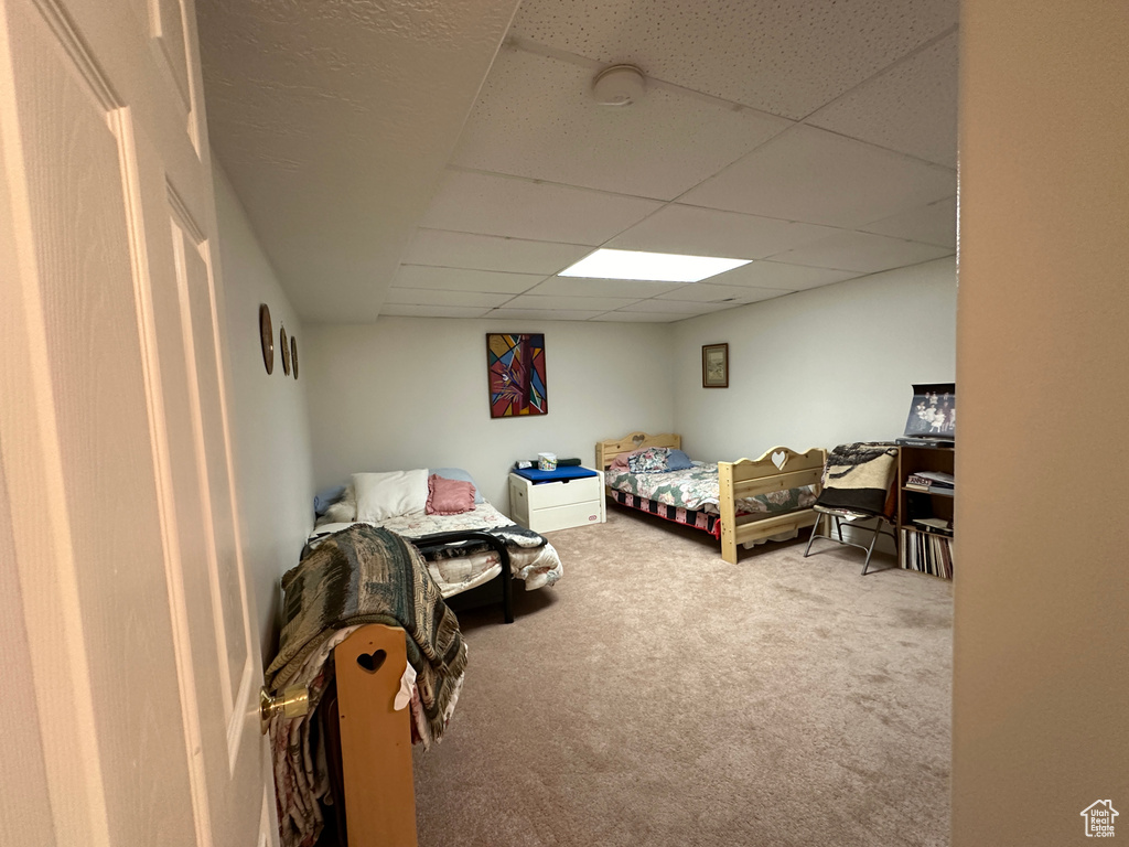 Carpeted bedroom with a drop ceiling