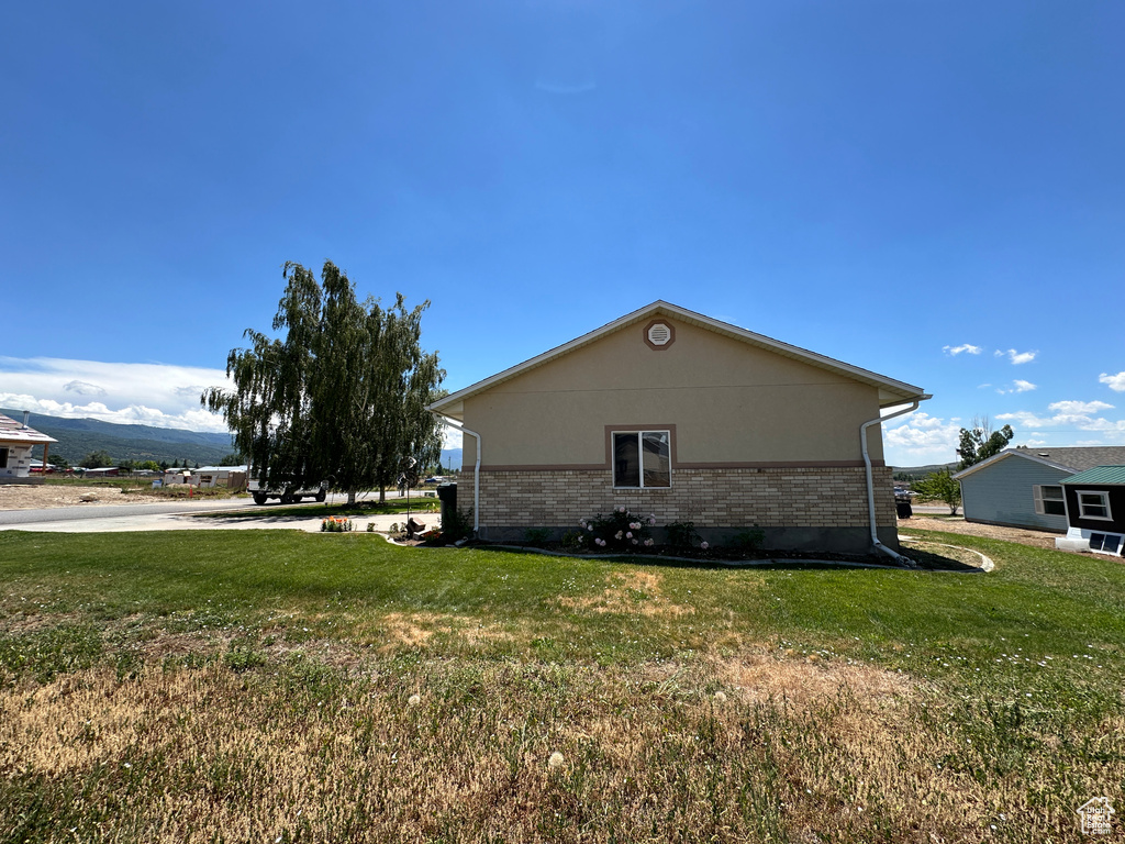 View of side of property with a yard