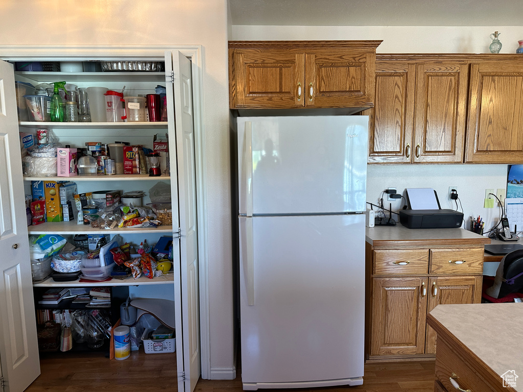 Kitchen featuring white fridge and hardwood / wood-style flooring