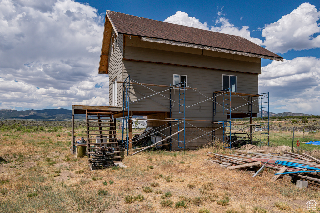 Back of property with a mountain view