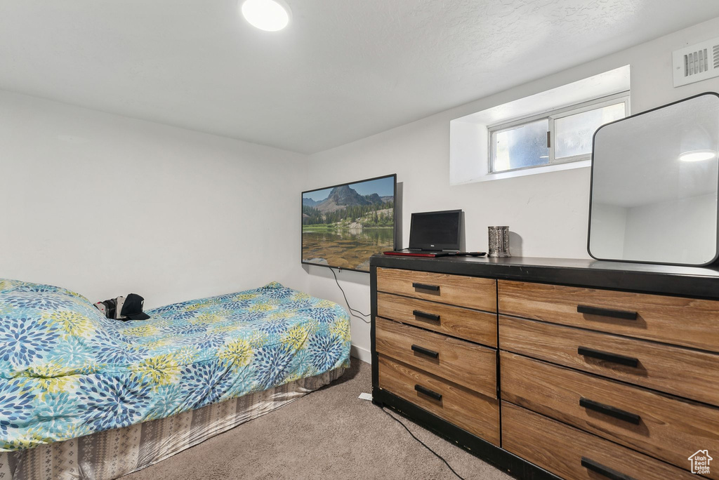 Bedroom featuring light colored carpet