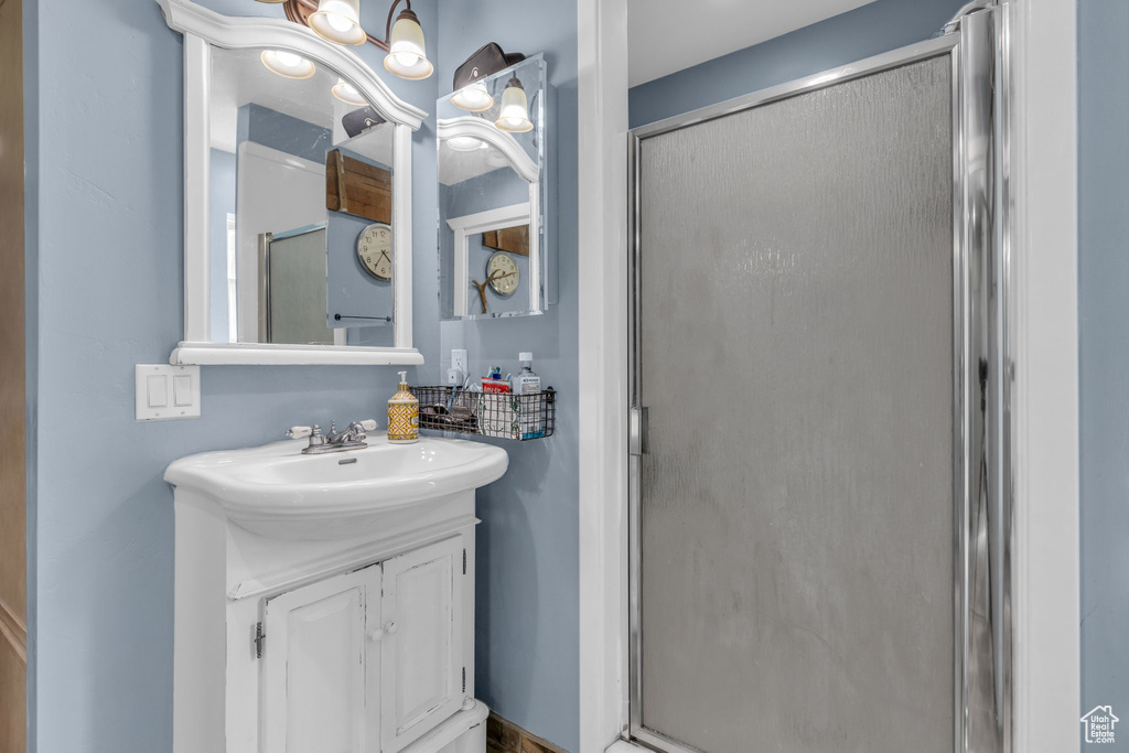 Bathroom with a shower with door and large vanity