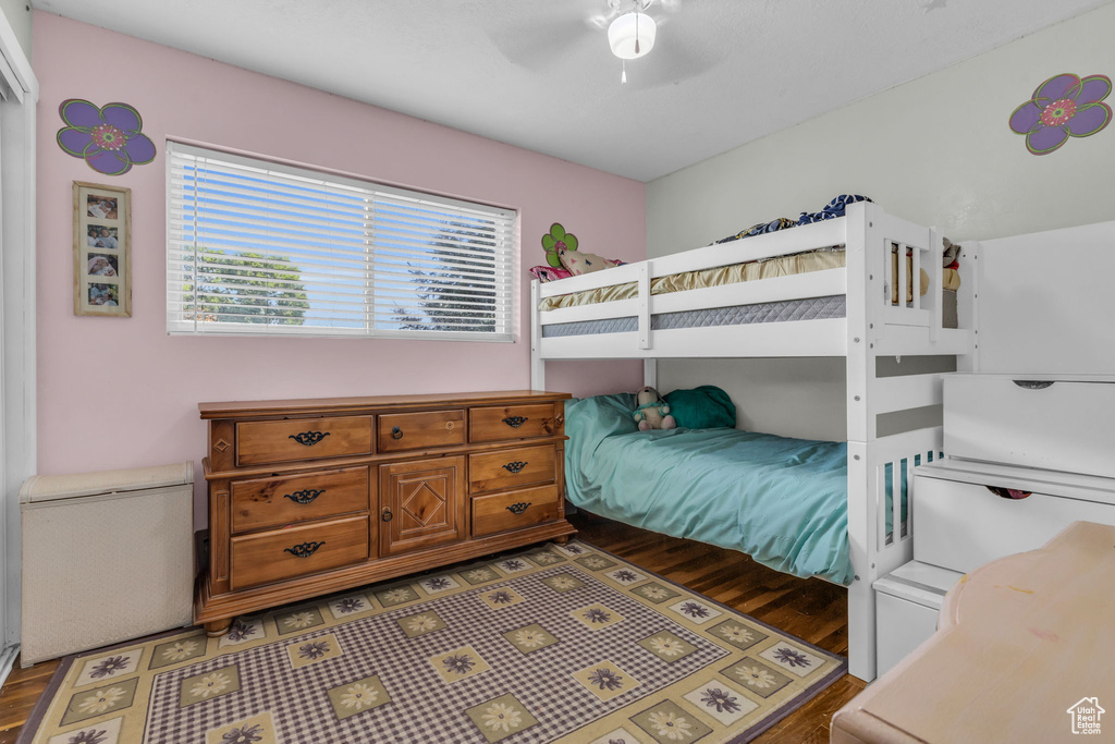 Bedroom with dark hardwood / wood-style flooring and ceiling fan