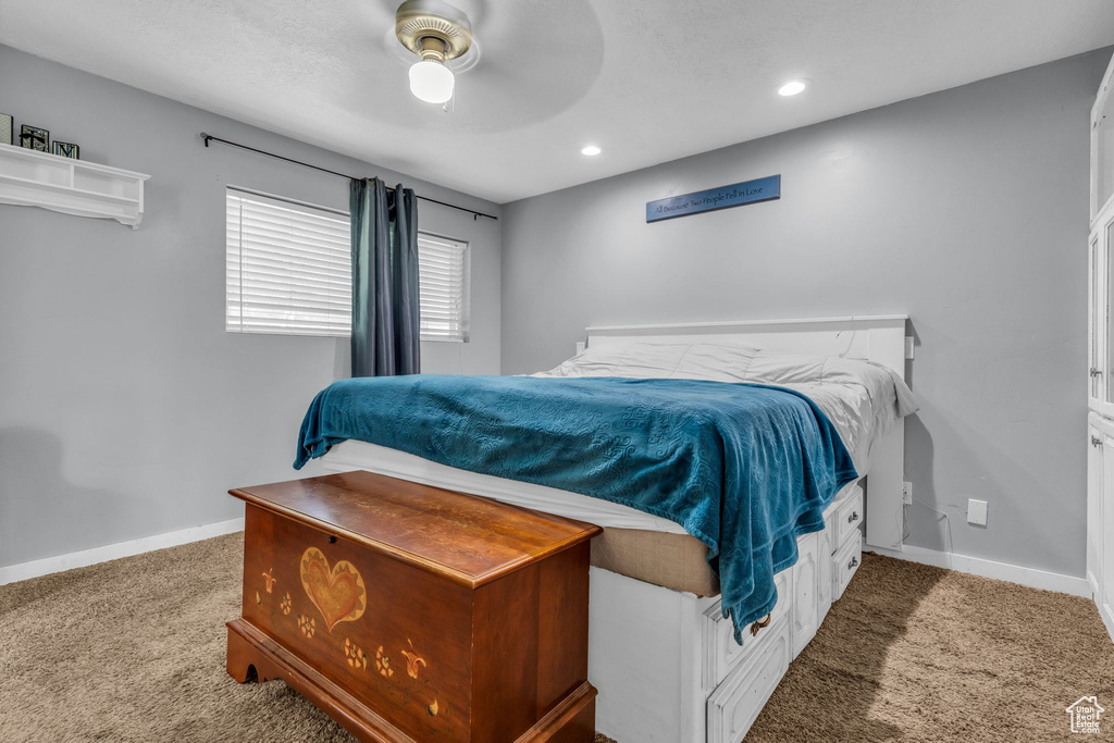 Carpeted bedroom with ceiling fan