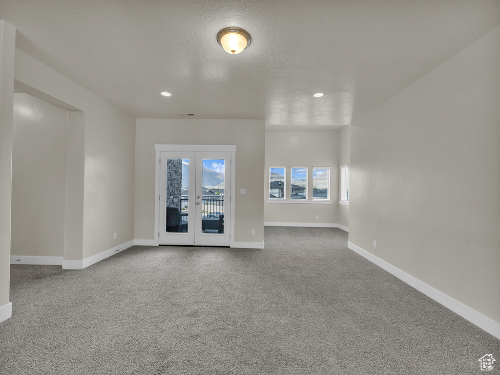 Empty room with baseboards, carpet, french doors, and recessed lighting