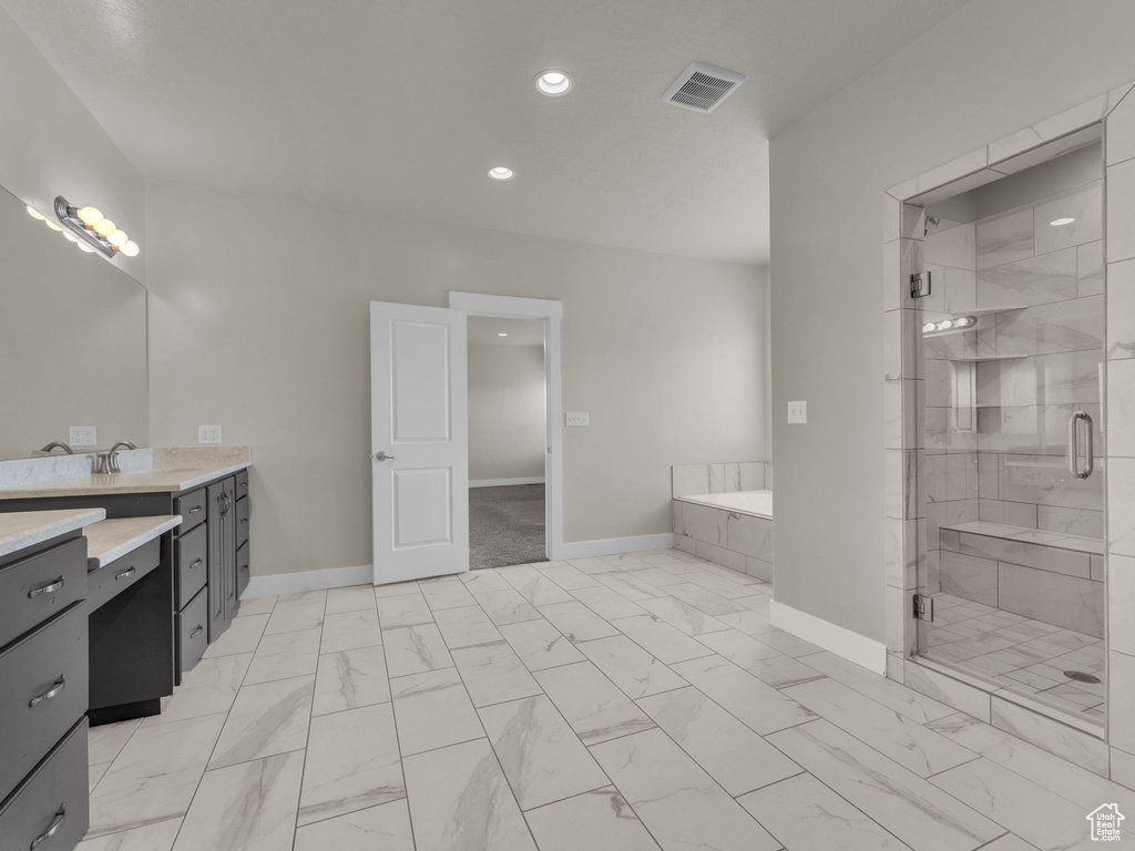 Full bath featuring visible vents, a stall shower, vanity, baseboards, and marble finish floor