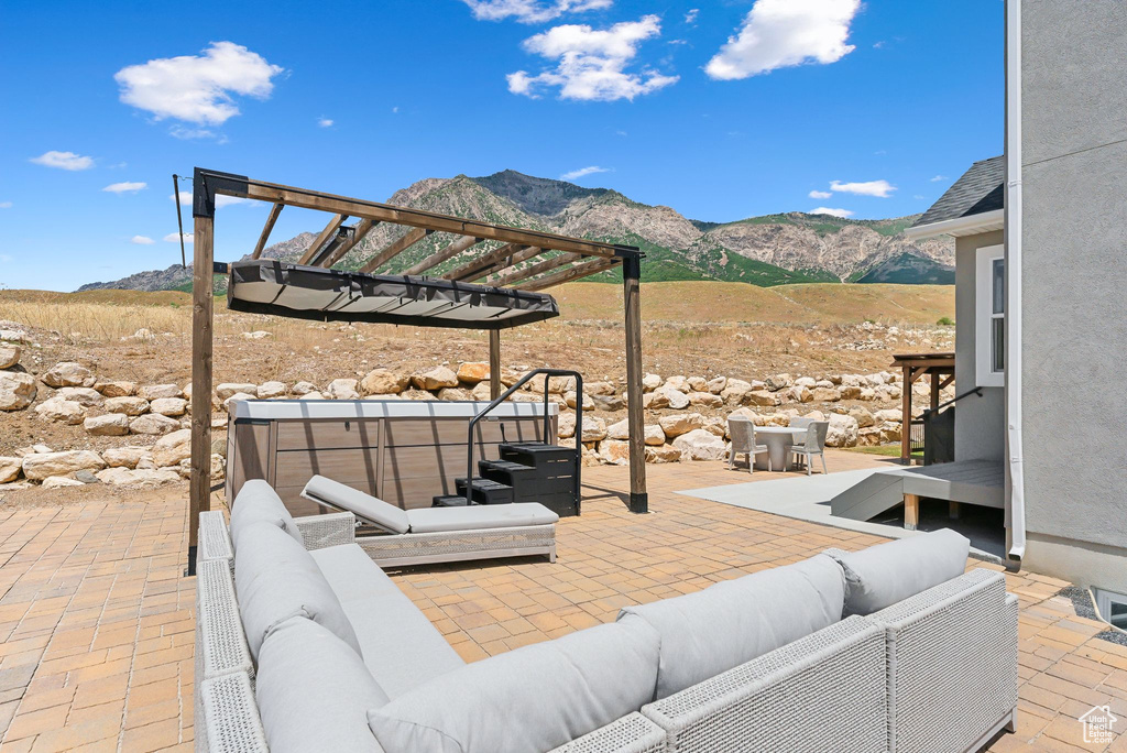 View of terrace featuring a mountain view, an outdoor living space, and a pergola