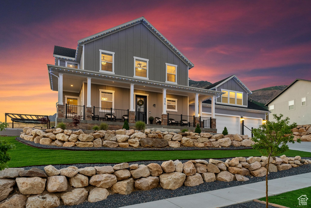 View of front of property with a garage and a porch