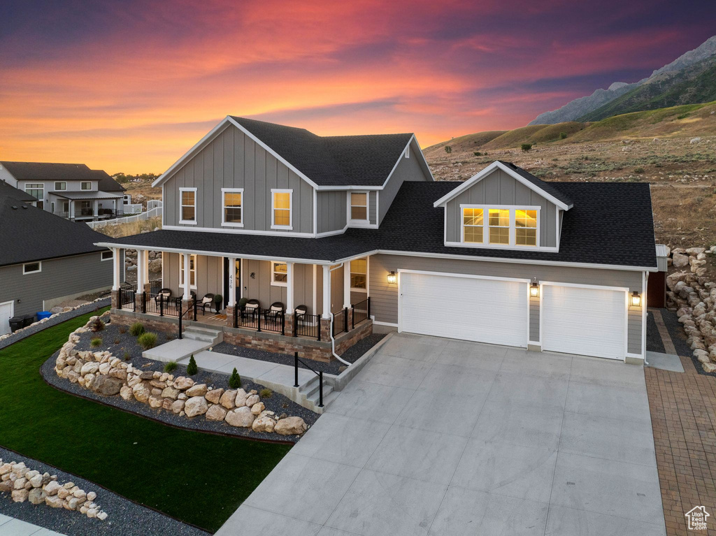 View of front of house with a garage and a porch