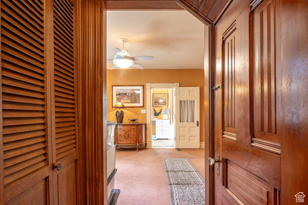 Hall featuring light carpet