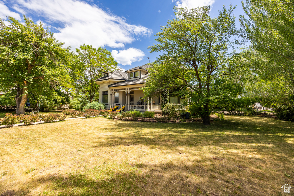 View of yard with covered porch