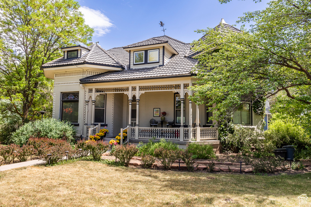 Exterior space with covered porch and a lawn