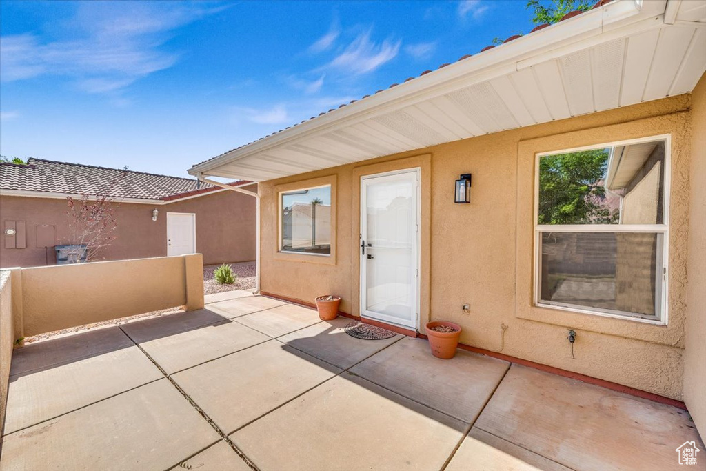 Doorway to property featuring a patio area