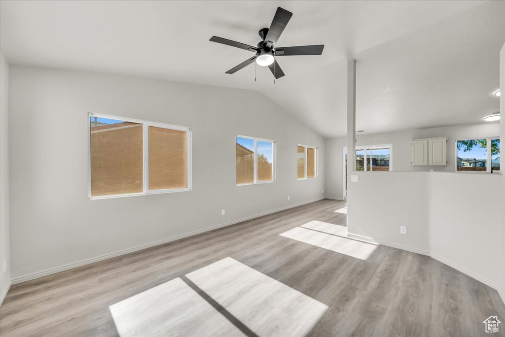 Unfurnished living room with ceiling fan, light hardwood / wood-style flooring, and vaulted ceiling