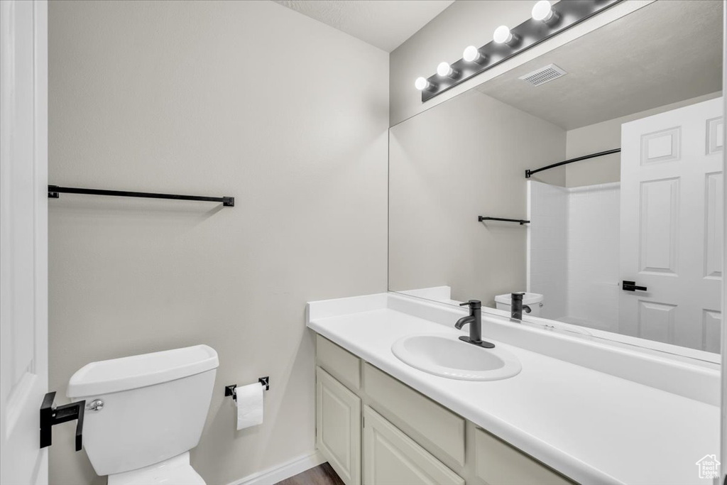 Bathroom featuring vanity and toilet