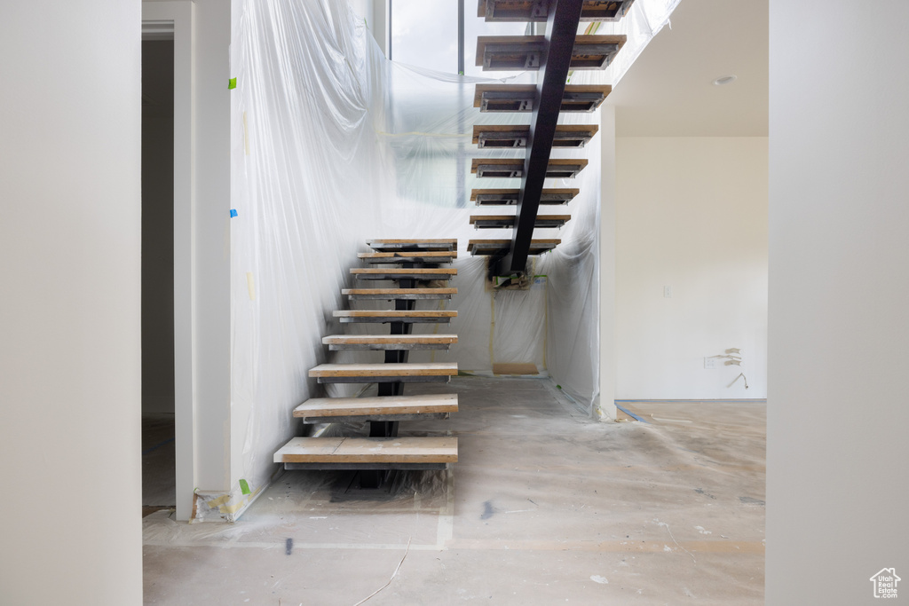 Stairs featuring concrete flooring