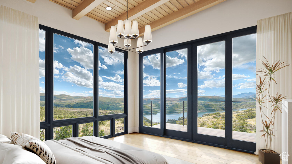 Bedroom with a notable chandelier, a water and mountain view, wood ceiling, beamed ceiling, and wood-type flooring