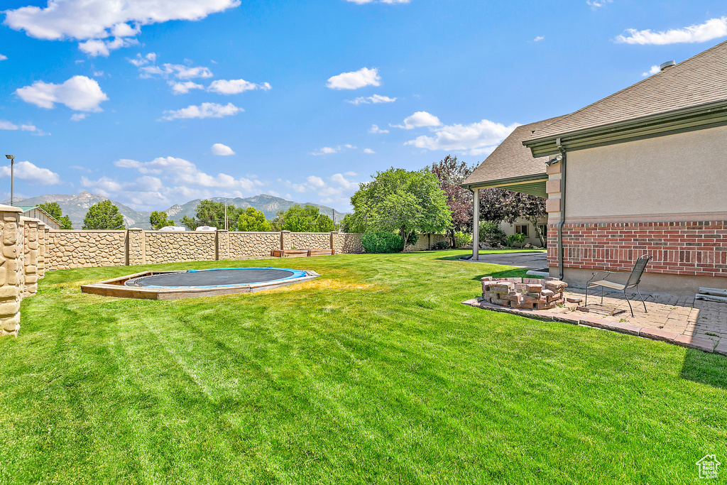 View of yard with a mountain view and a patio area