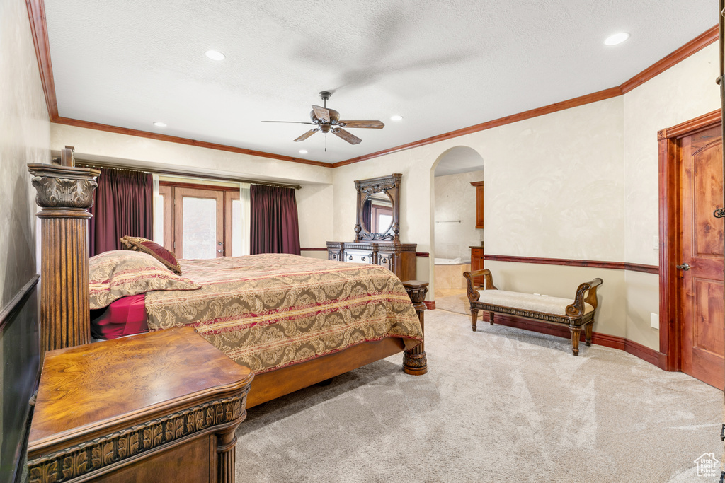 Carpeted bedroom featuring crown molding and ceiling fan