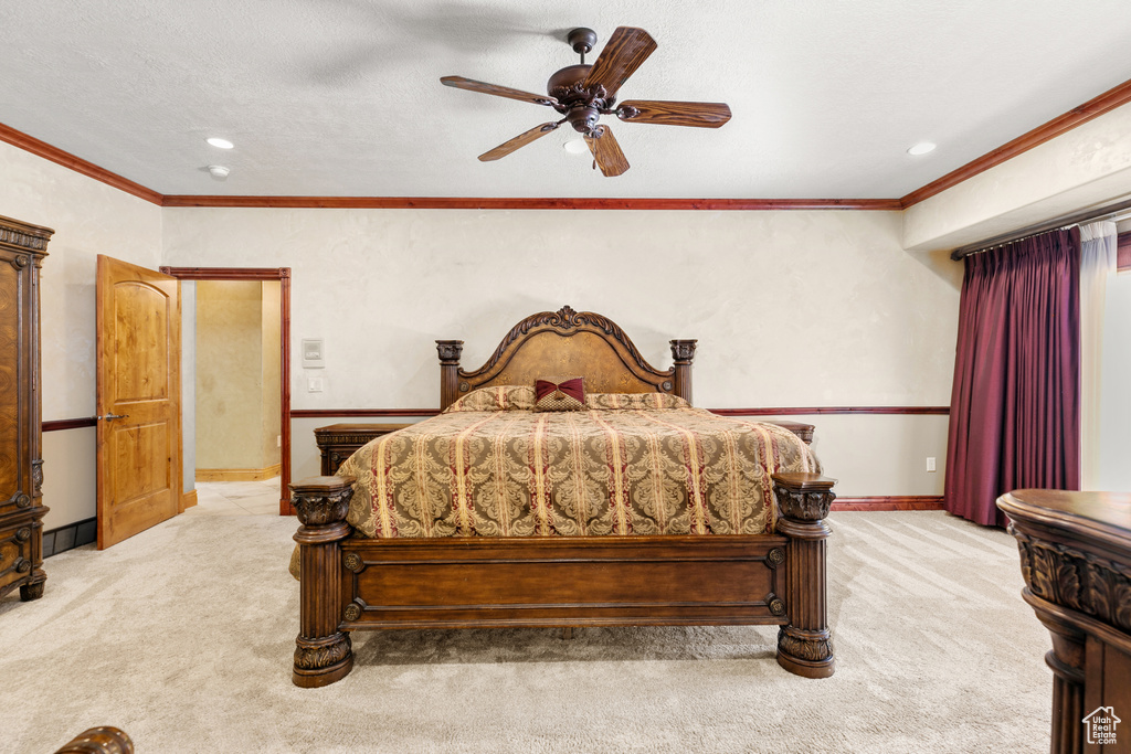 Bedroom with light carpet, ceiling fan, and crown molding