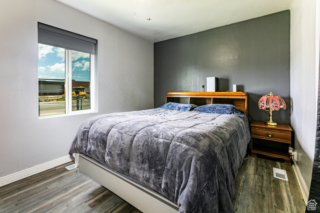 Bedroom with dark wood-type flooring