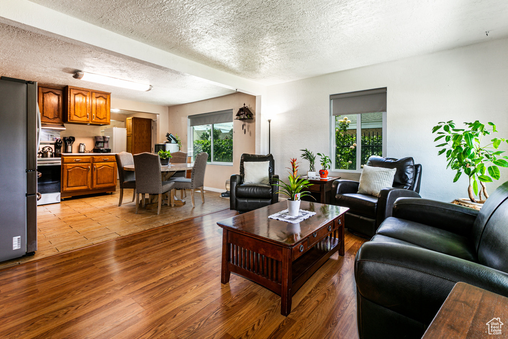 Living room with a textured ceiling and light tile floors