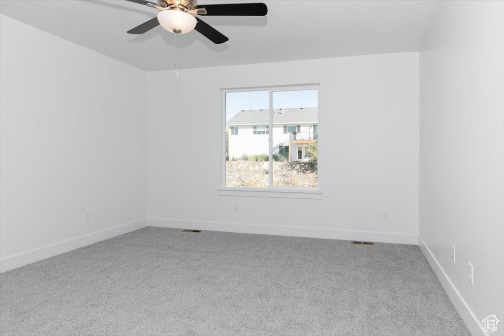 Spare room with carpet floors and ceiling fan