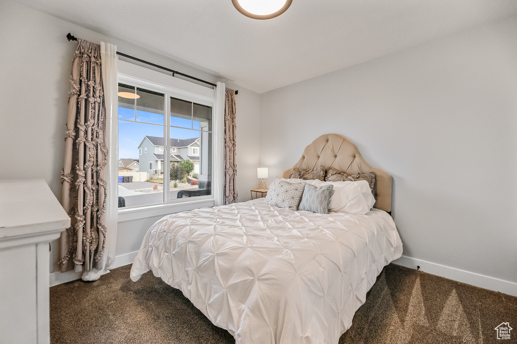 Bedroom featuring dark colored carpet