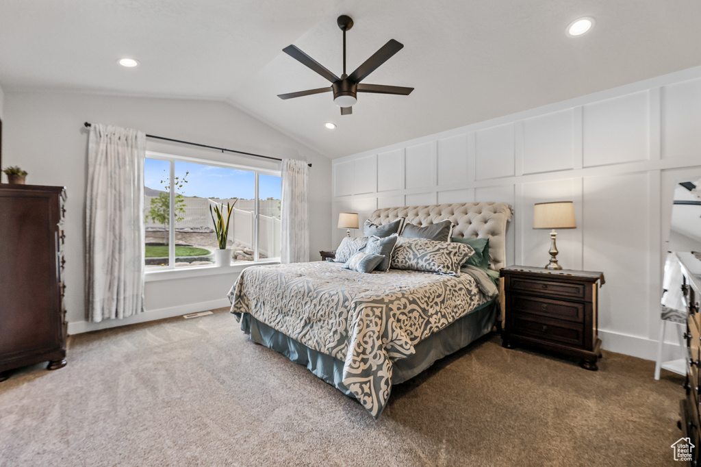 Bedroom featuring ceiling fan, carpet floors, and lofted ceiling