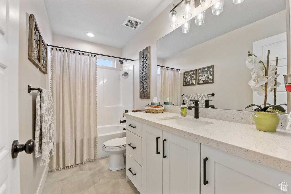 Full bathroom with tile flooring, vanity, toilet, and shower / tub combo