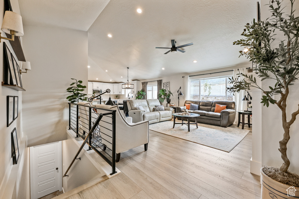 Living room featuring light wood-type flooring and ceiling fan