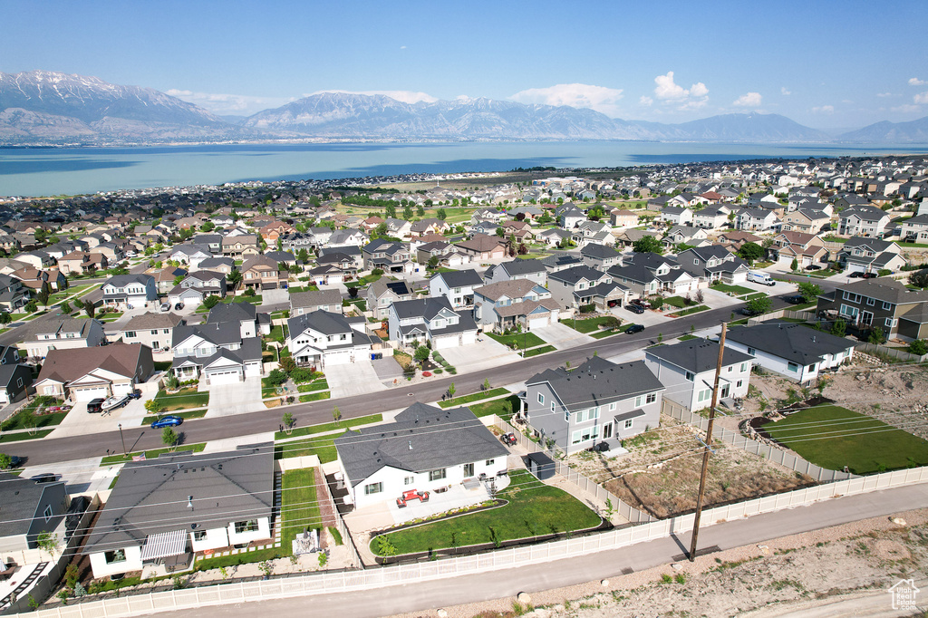 Drone / aerial view featuring a water and mountain view