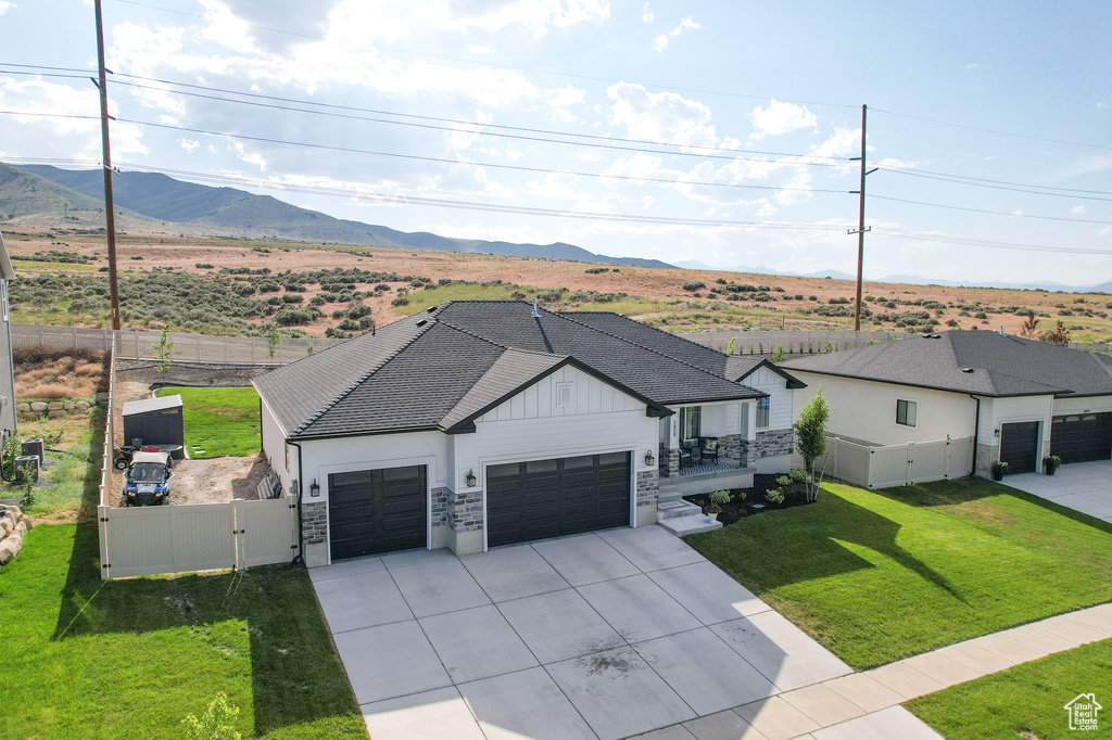 View of front of house featuring a front lawn and a mountain view