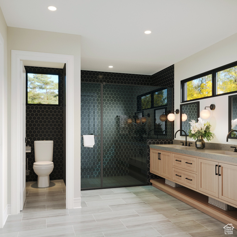 Bathroom with tile floors, double sink vanity, and toilet