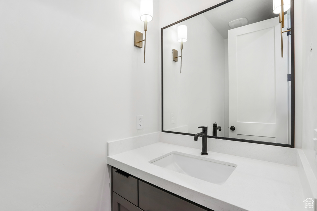 Bathroom with vanity with extensive cabinet space